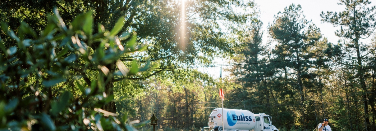 Euliss technician walking from truck to give propane delivery