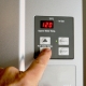 hand adjusting set temperature on tankless water heater