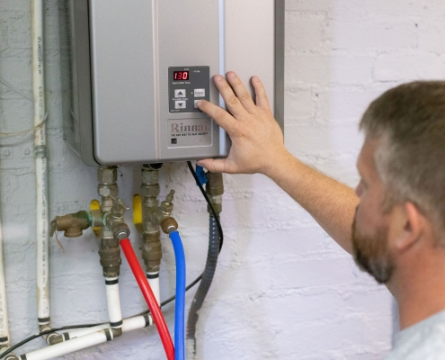 technician adjusting tankless water heaters