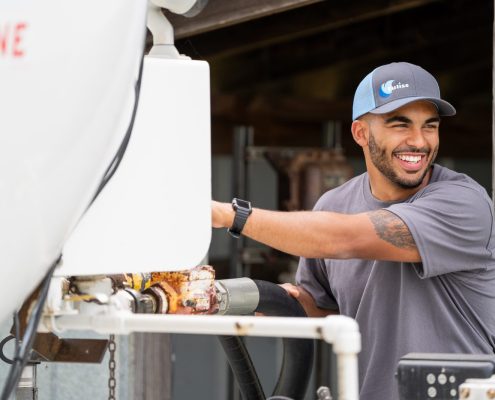 Propane technician smiling while making a delivery for propane heat