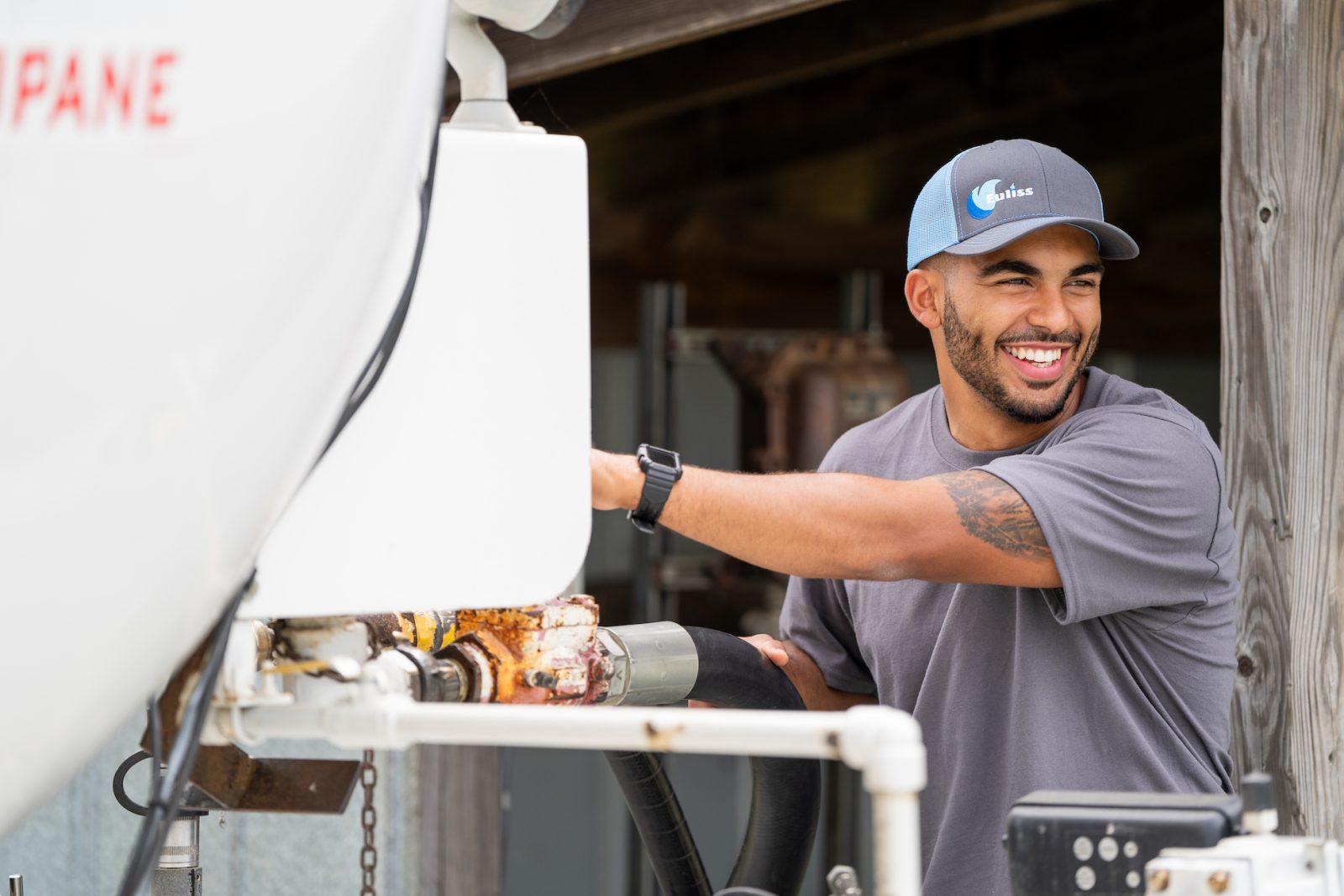 Propane technician smiling while making a delivery for propane heat