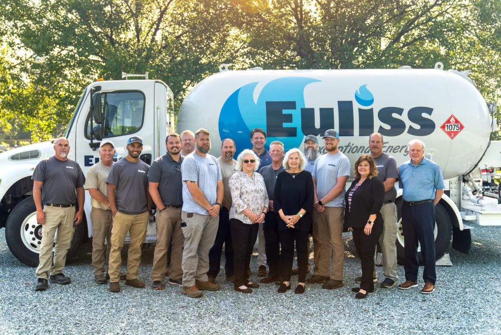 The Euliss Team standing together as a group in front of a propane truck.