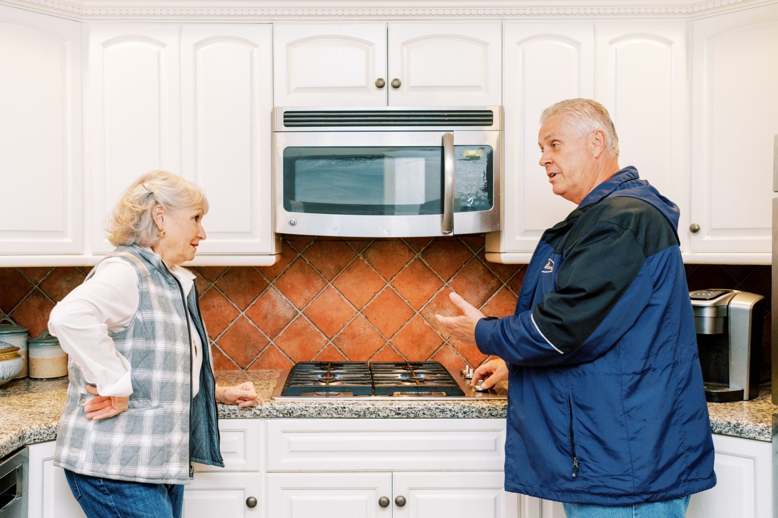 Euliss representative discussing the benefits of a gas stove with a customer.