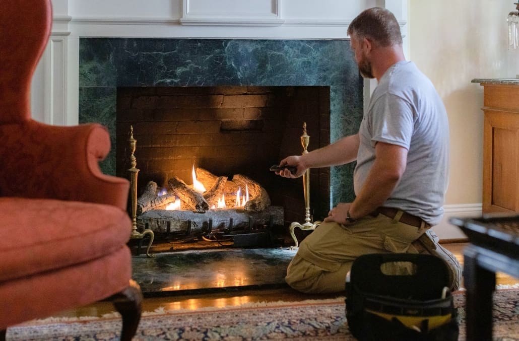 Euliss technician performing maintenance services on gas logs in Pleasant Garden, NC.