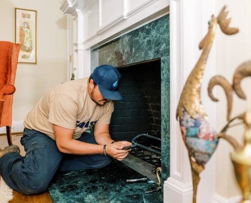 A Euliss technician installing a gas fireplace in a North Carolina home.