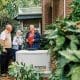 Euliss technician and two customers discussing propane generators with a Generac Generator installed.
