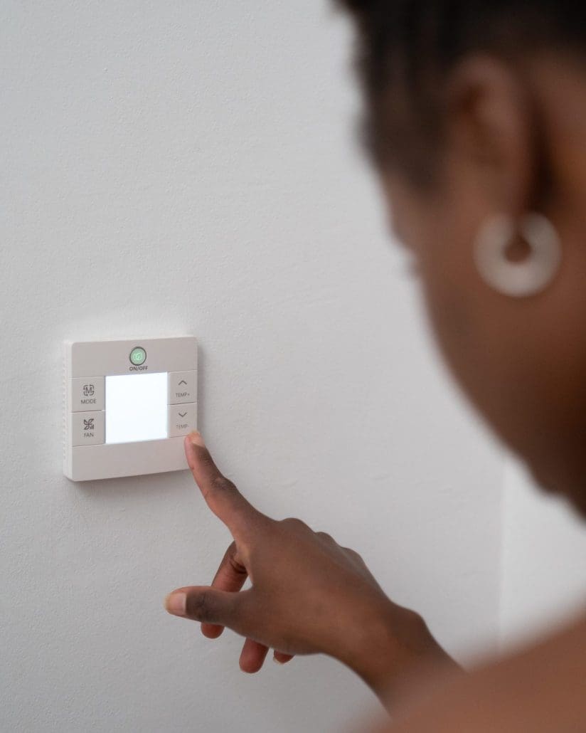 Homeowner adjusting a thermostat to lower their propane ussage.