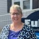 Amy Johnson, Euliss Propane Customer Service Representative, posing for headshot in front of Euliss sign.