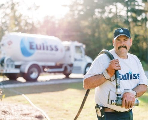 Euliss delivery driver filling up a propane tank.