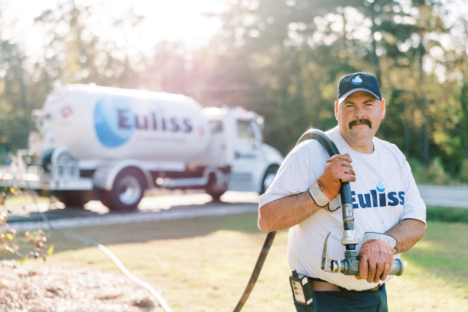 Euliss delivery driver filling up a propane tank.