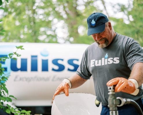 Euliss employee by a propane tank