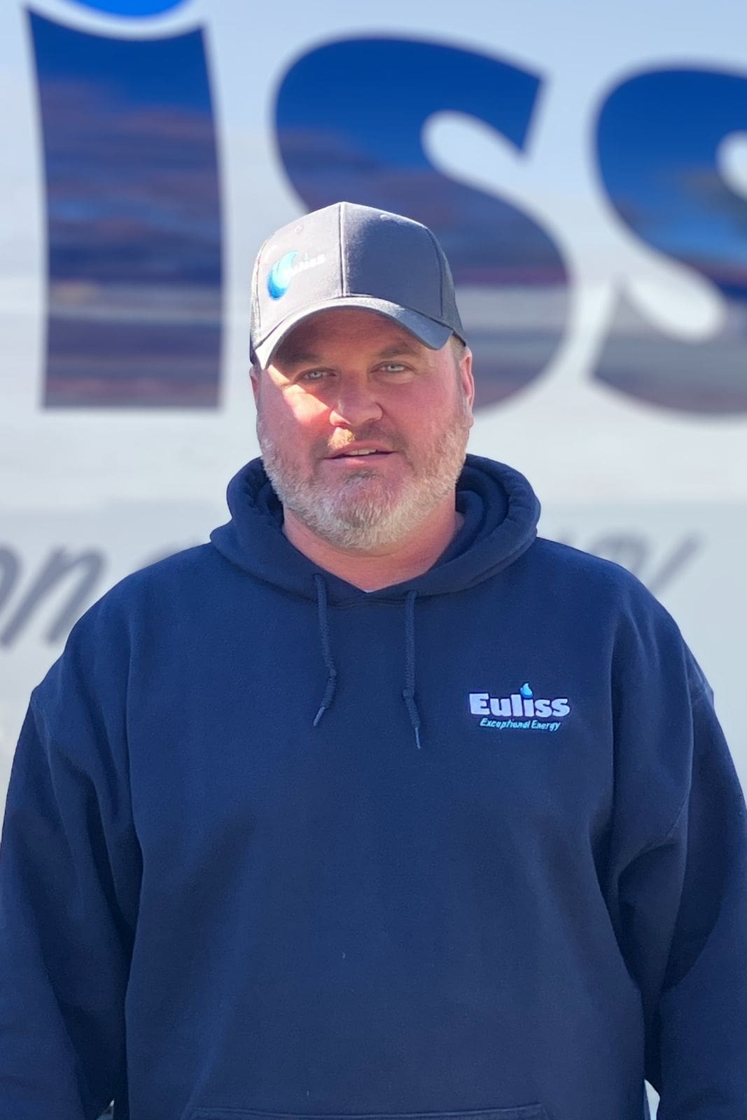 Nate Smith, Euliss Propane Delivery Driver and Service Technician, standing in front of a propane bobtail, posing for this headshot.