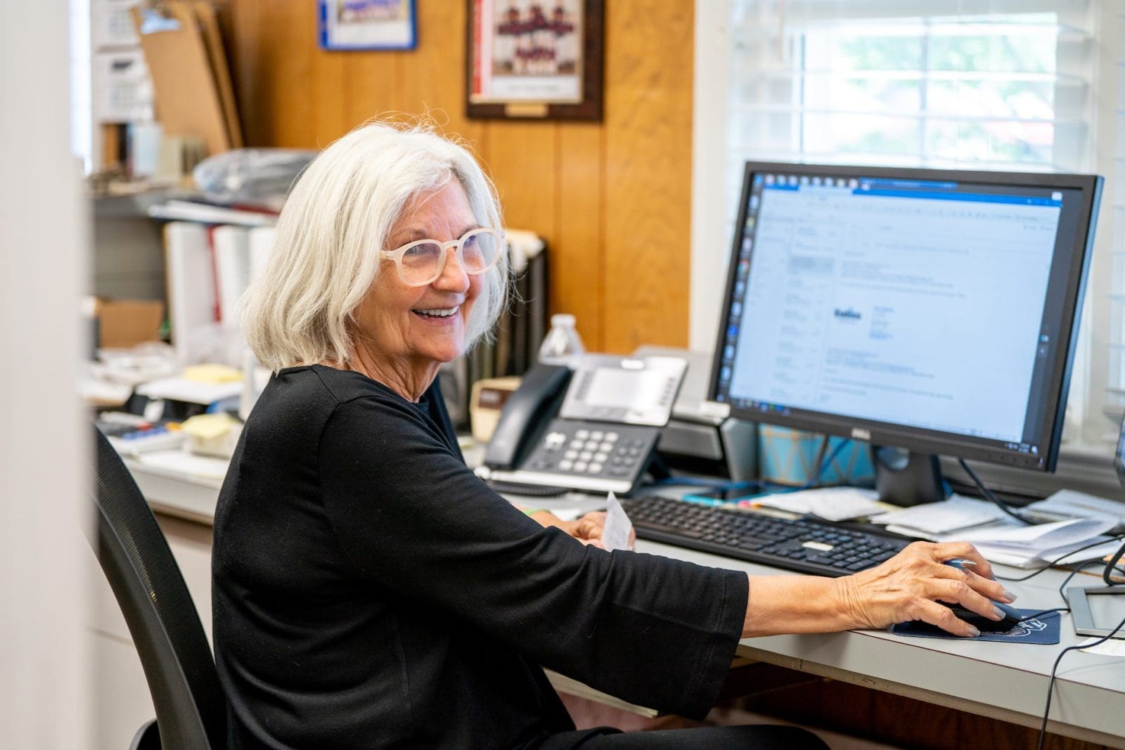 Euliss customer service representative smiling at desk